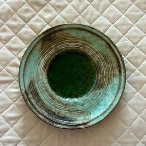 Decorative handmade pottery plate with glazed center